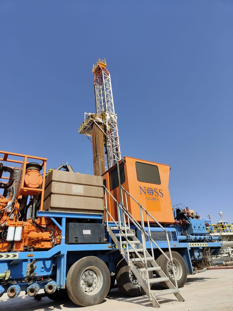 NOSS pumping unit rigged up beside a rig on location